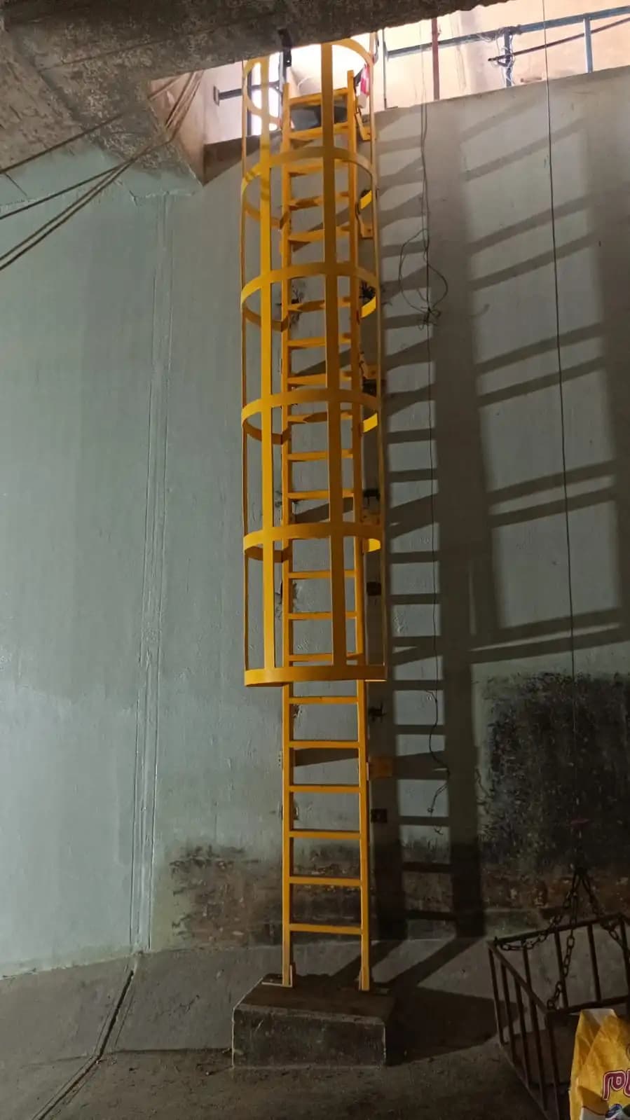 Installed caged GRP access ladder at a project site